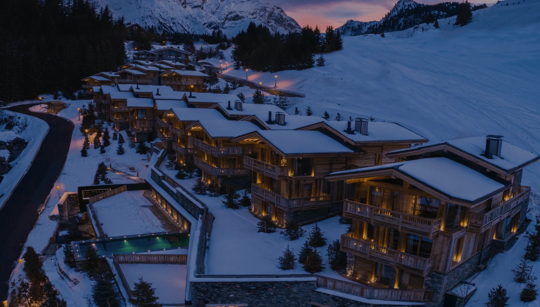 Nova Luxe mountain resort at twilight with illuminated windows